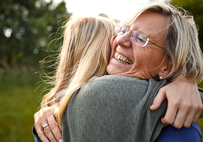 Elderly mother and daughter embracing