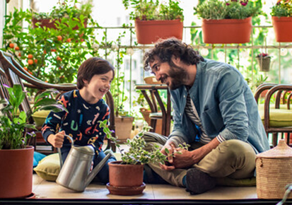 Father and son watering the plants