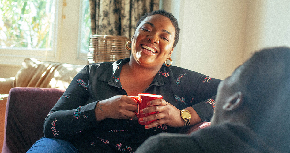 Woman smiling, having a cup of tea