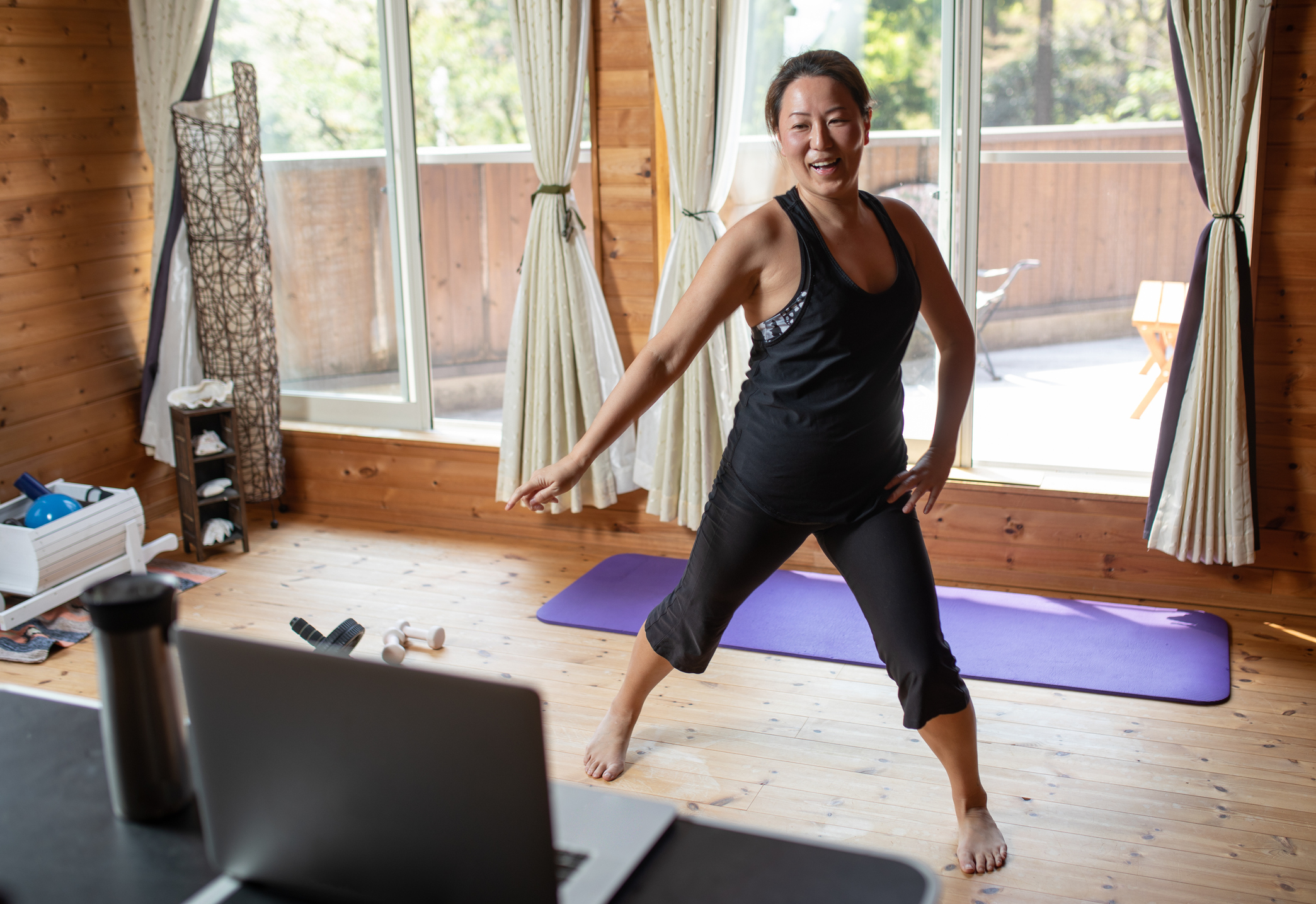 Vigorous Energetic Woman Doing Yoga with Kettlebell Weight