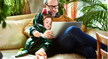 Man on laptop with child