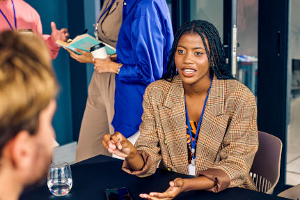 Younger professional lady talking to a colleague