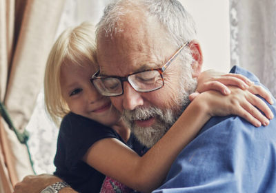 A middle-aged man smiling with a woman 